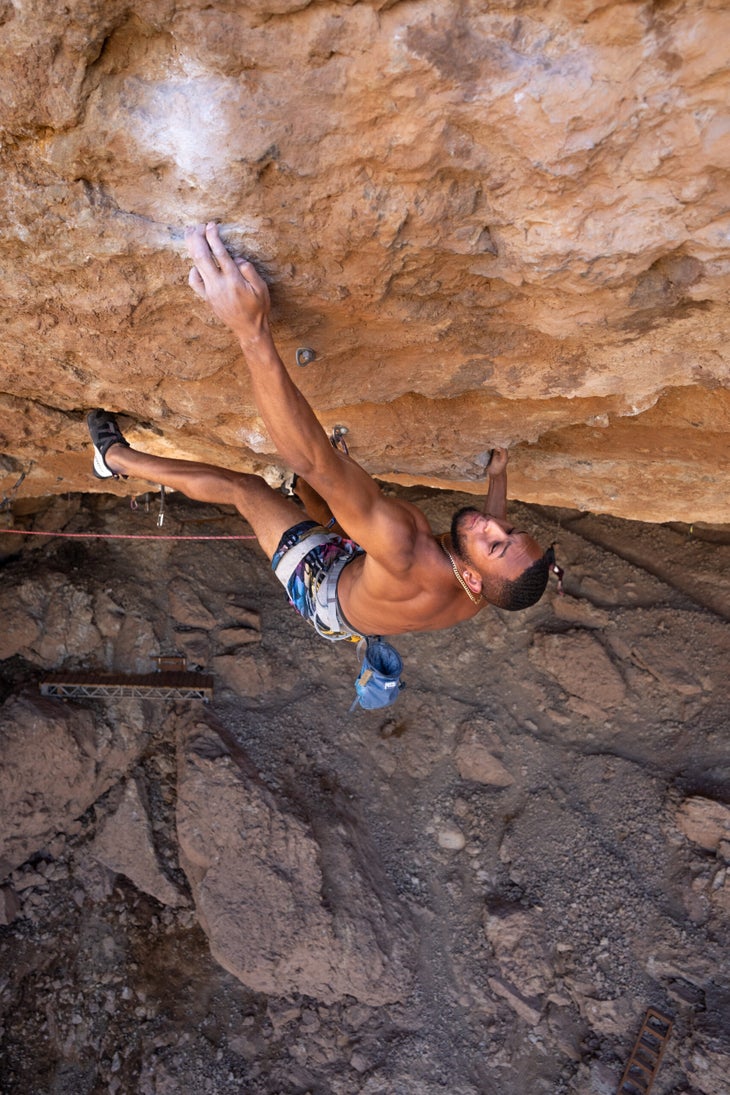 man climbing hard route