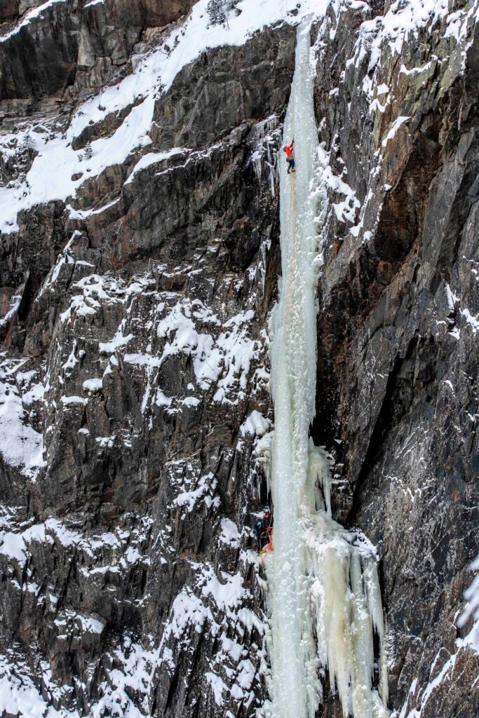 an ice pillar with a climber