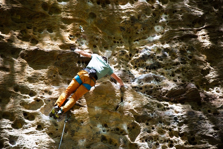 a climber on holey rock