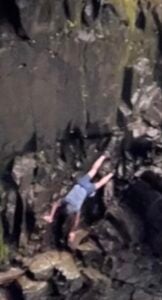 man descending rock upside down