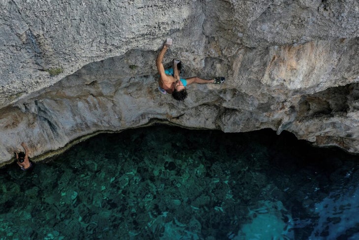 a climber deep water soloing