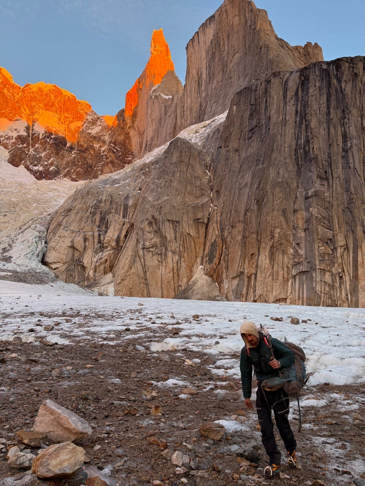 Hiking across the Torre Glacier at sunrise, with the East Face of Cerro Torre cast in alpenglow.