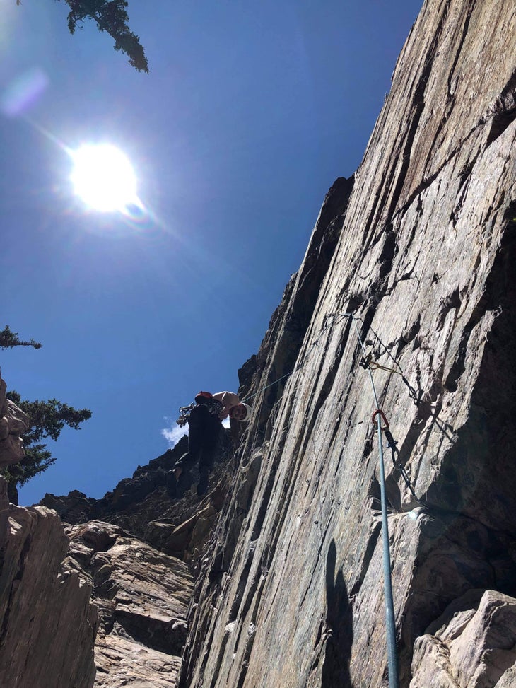Hanging from the end of my rope after a giant whip off Scared Peaches. The crux roof is visible far above me. The author would go on to analyze climbing accidents for several years.