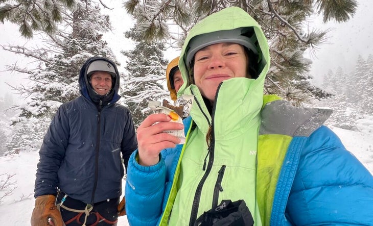 a girl holding up a protein bar