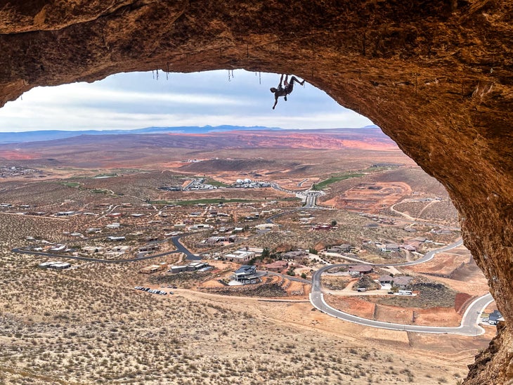 man climbing in a cave