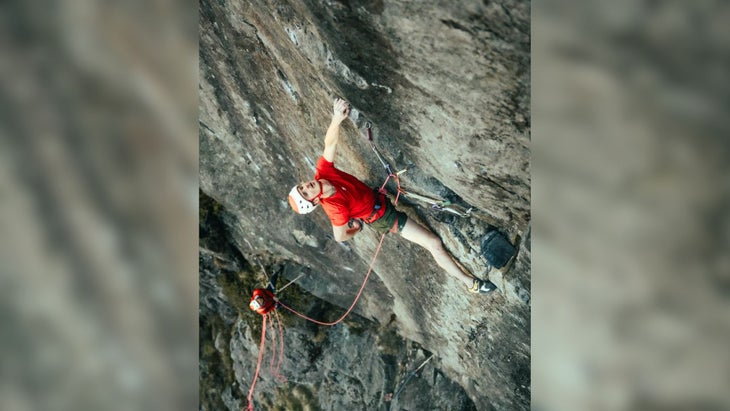 Adam Ondra rests at the last nest of gear before the run out on 'Lexicon' (5.14 R).
