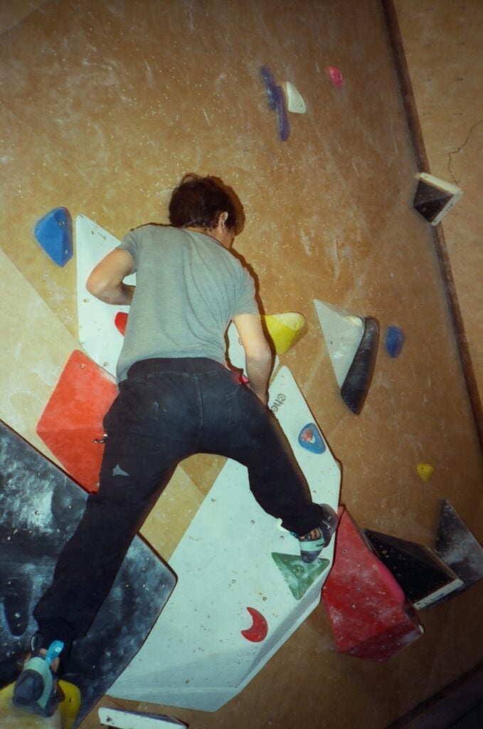 a kid climbing at the gym 