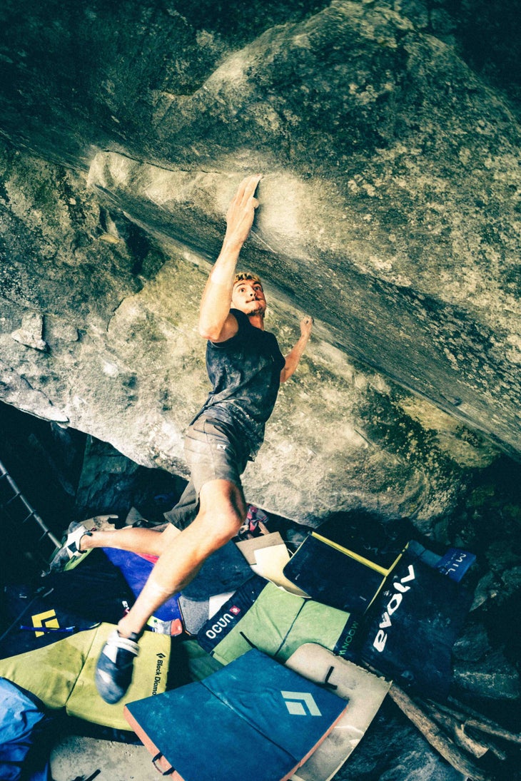 Male climber ascends steep V15 boulder, becoming the first person to flash it.