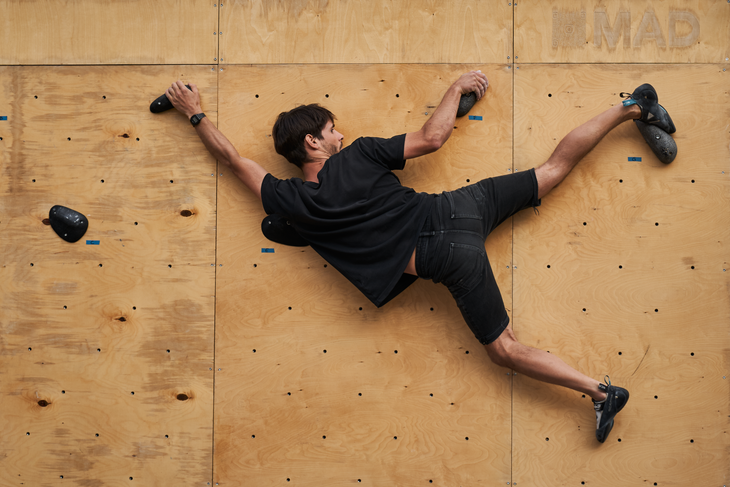 a climber climbing on holds made from mushrooms