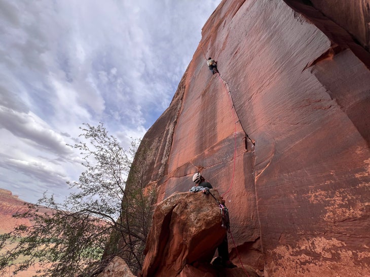 A climber in a finger crack in Indian Creek