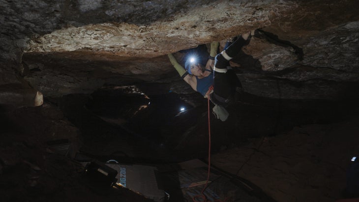 Mary Eden climbing a roof crack in the dark