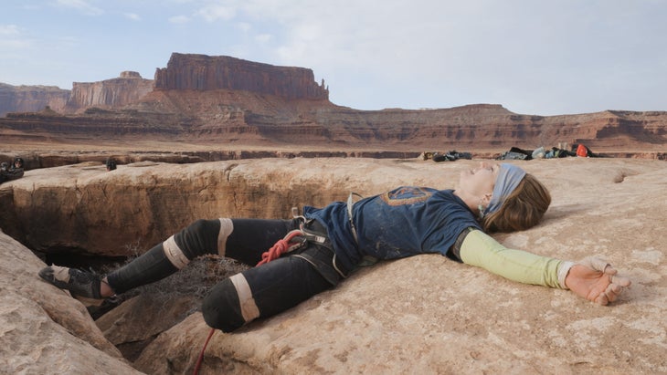 Mary Eden lying down on top of Black Mamba