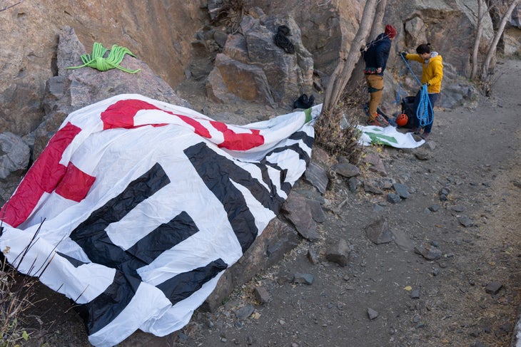 Climbers in Golden prepare to rig the 25-by-8-foot "Stop the Genocide" banner.