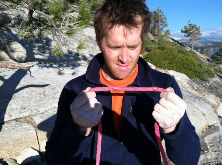 James Lucas examines his cut rope after a fall in Yosemite.