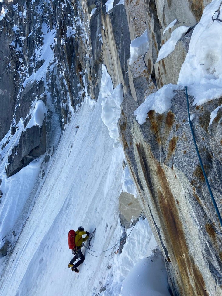 Climbers leds a traverse of steep alpine ice while making the first ascent of a major alpine climb in the Himalaya.