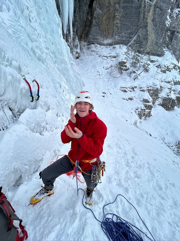 Applying glitter at the base of Pilsner Pillar (WI6), Canadian Rockies.