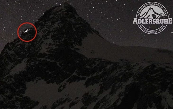 Webcam footage of mountain at night with climbers' headlamps visible. The surviving climber was later charged with manslaughter.