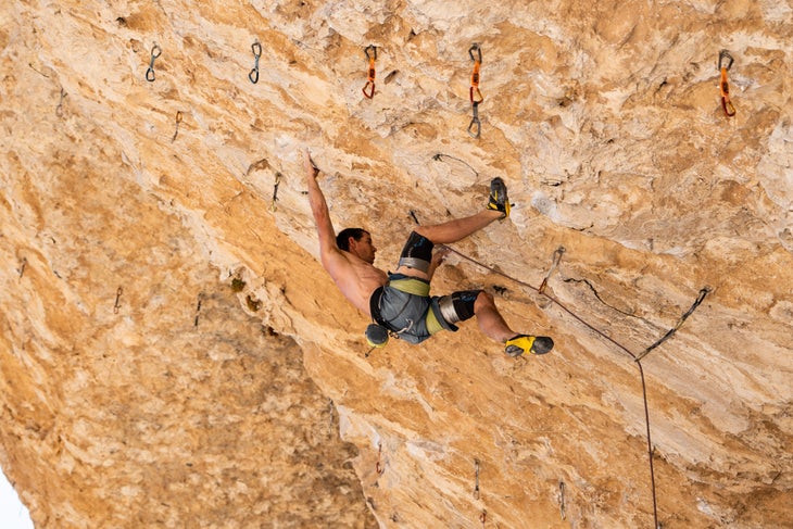 Alex Honnold climbing a very steep route in a cave in Nevada