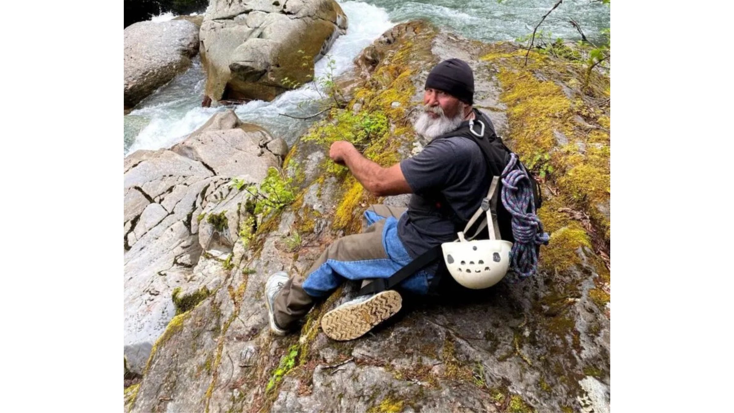 Earl Prunty, shown sitting on rocks in front of rushing water with climbing gear attached to back, died on March 17, 2025