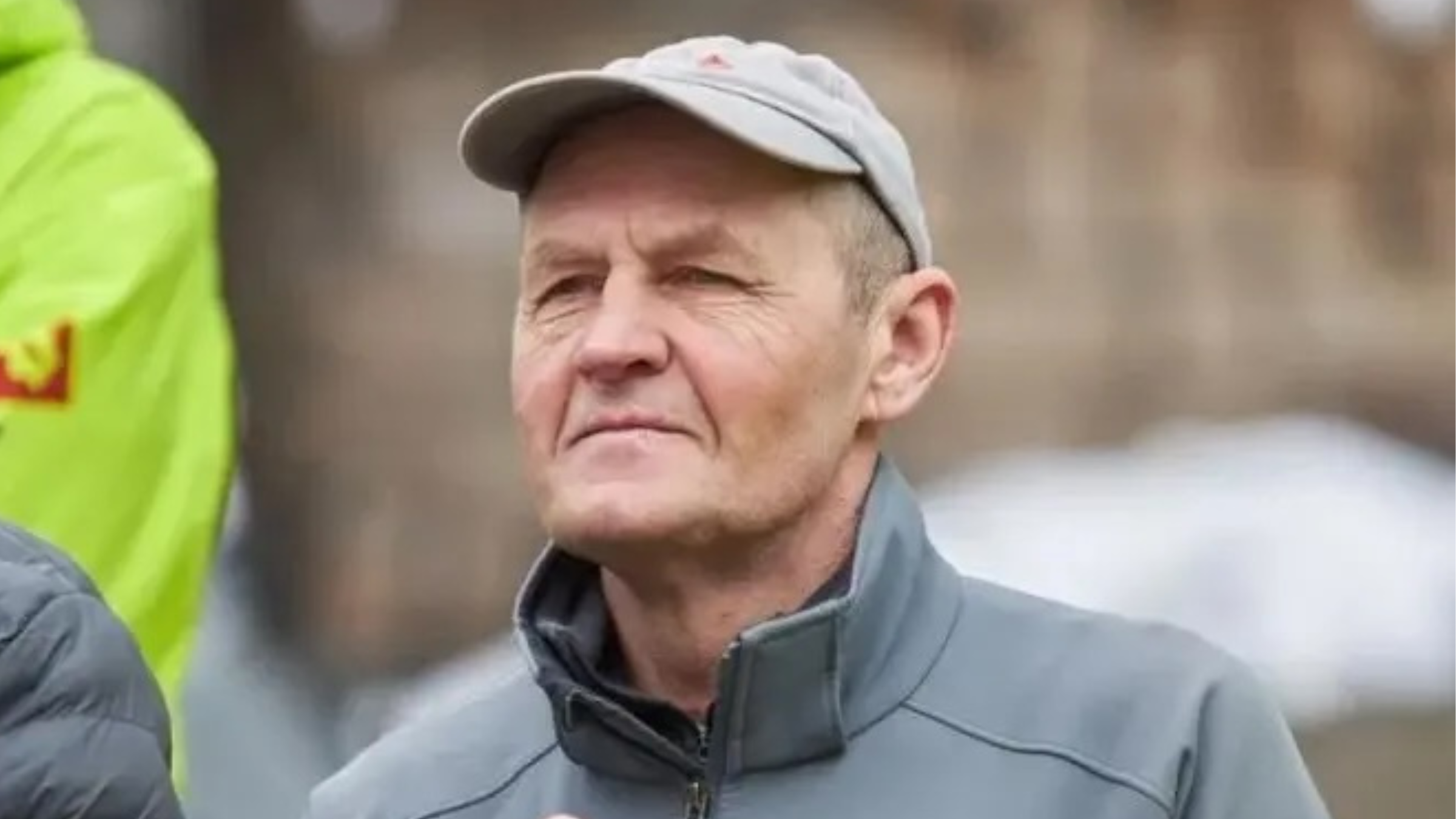 Russian climber Nikolay Totmyanin, seen here in a gray cap and gray half-zip jacket, died on August 11, 2025