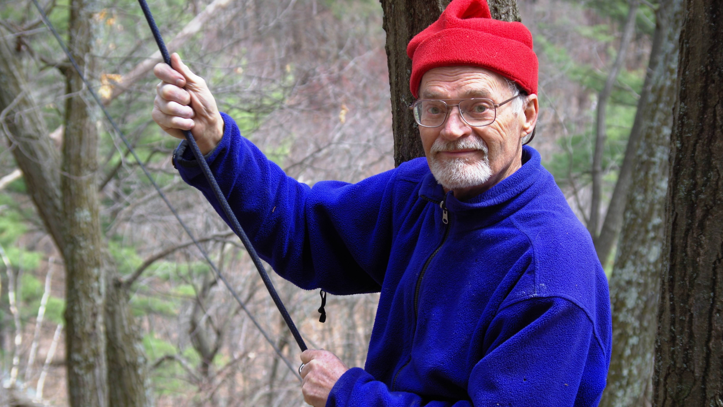 legendary climber Pete Cleveland, seen here holding a rope with a red beanie and bright blue jacket, died on October 7, 2025