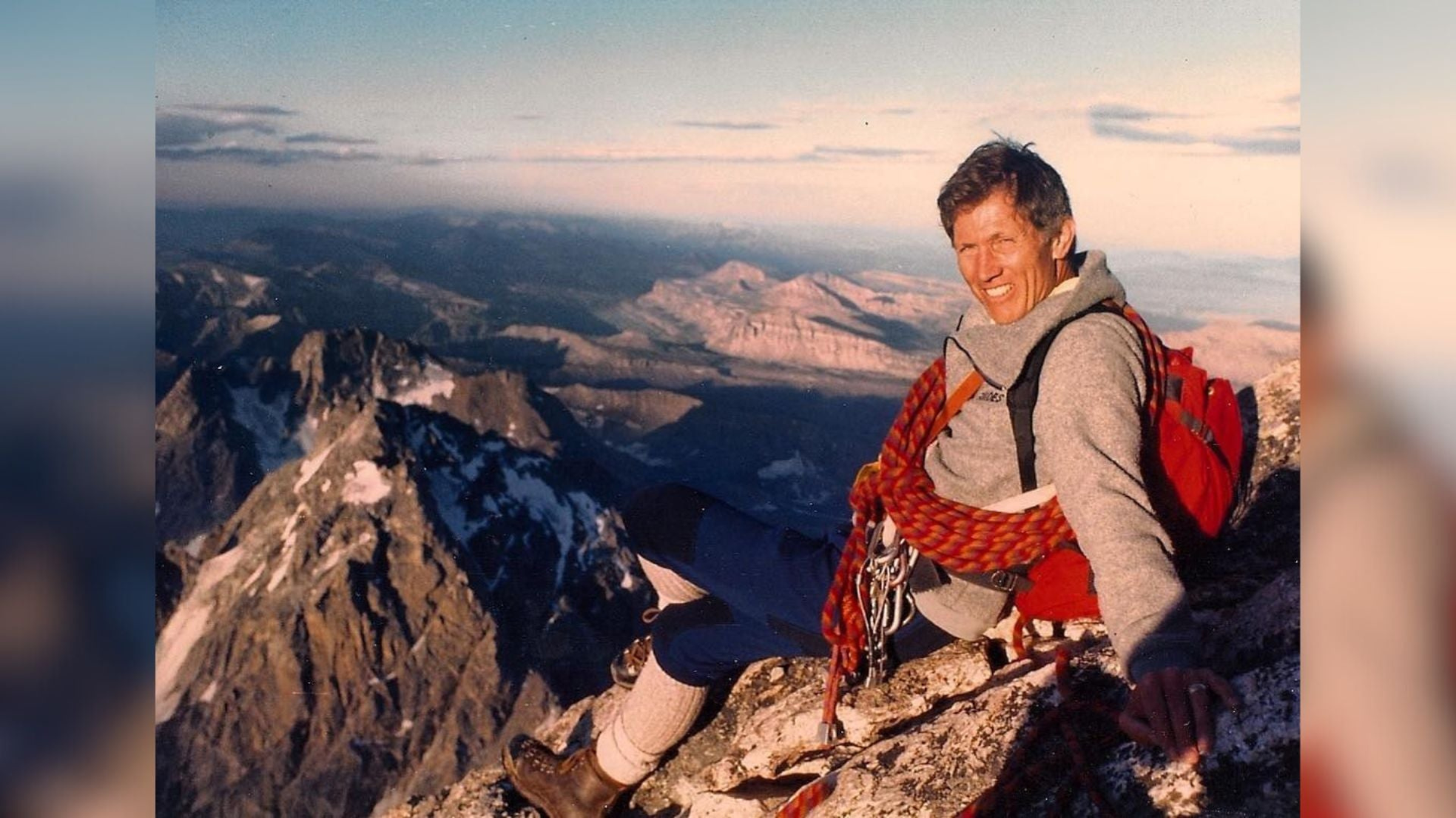 climber Peter Lev, who sits at top of mountain with mountains in the background and climbing ropes around body, died on April 27, 2025