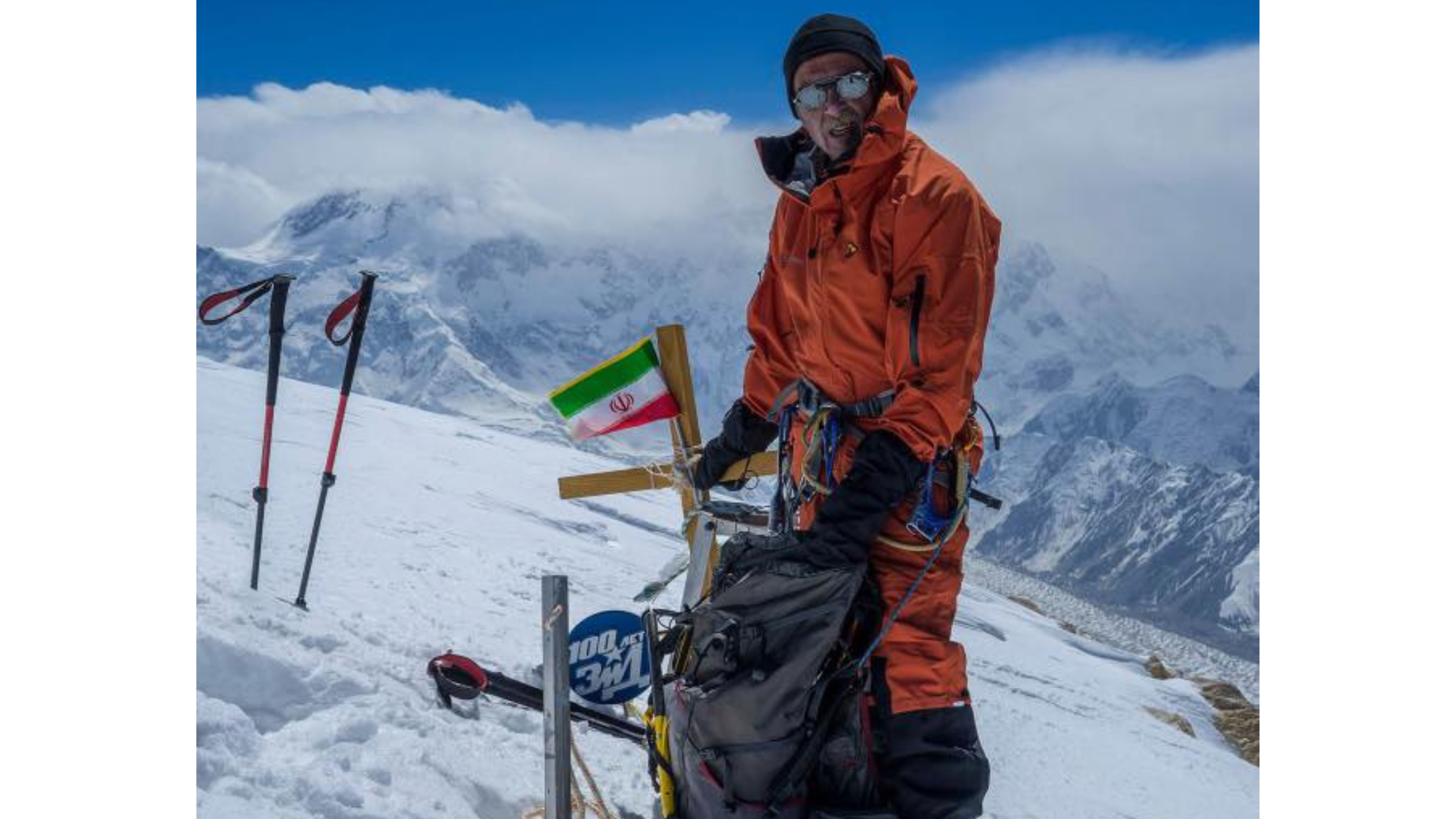 climber Gleb Sokolov, seen in orange climbing suit at top of snow-covered mountain peak, died on May 9, 2025