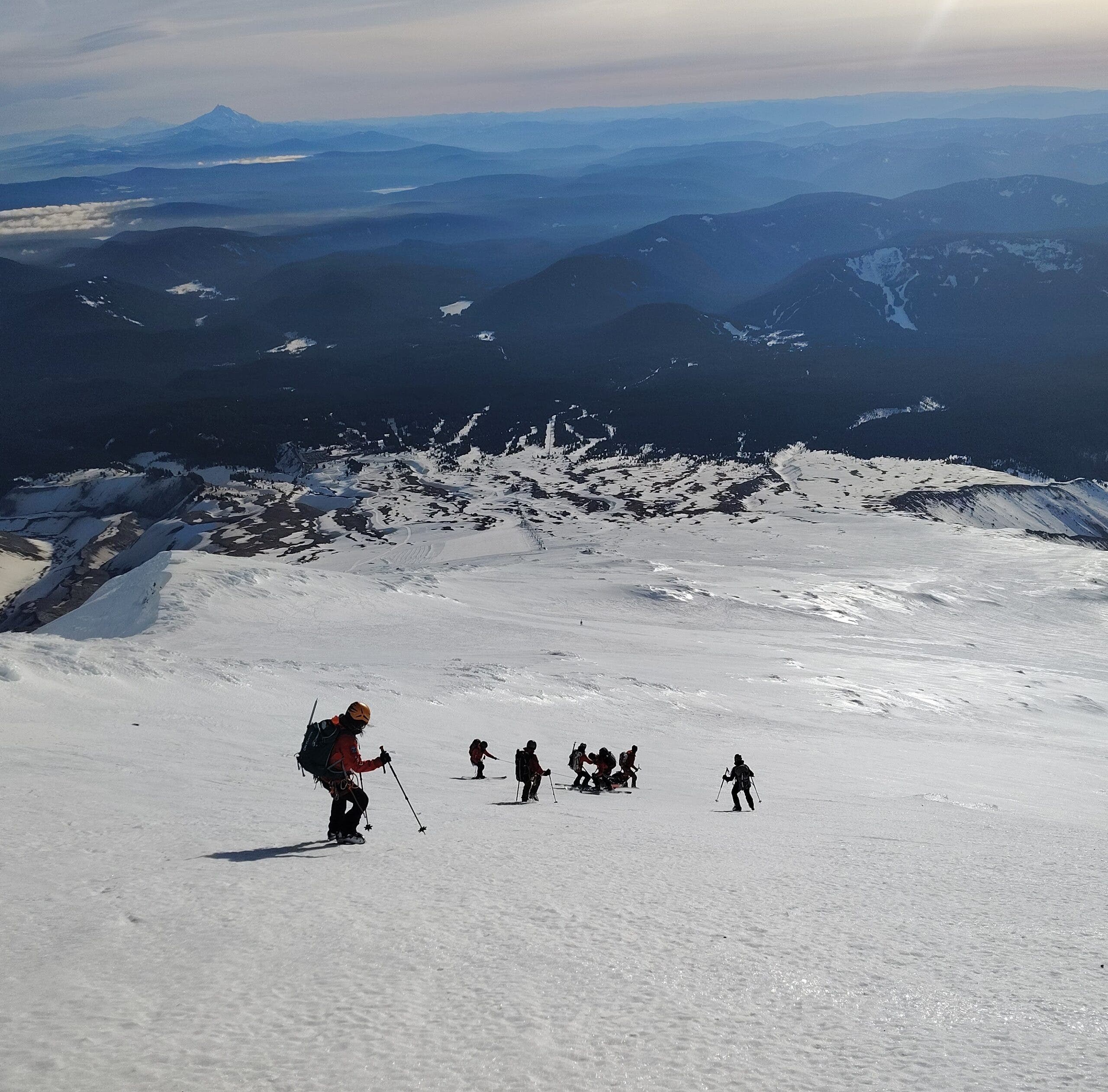 Portland Mountain Rescue workers lower a rescue litter down the icy terrain on Mount Hood's lower flanks.