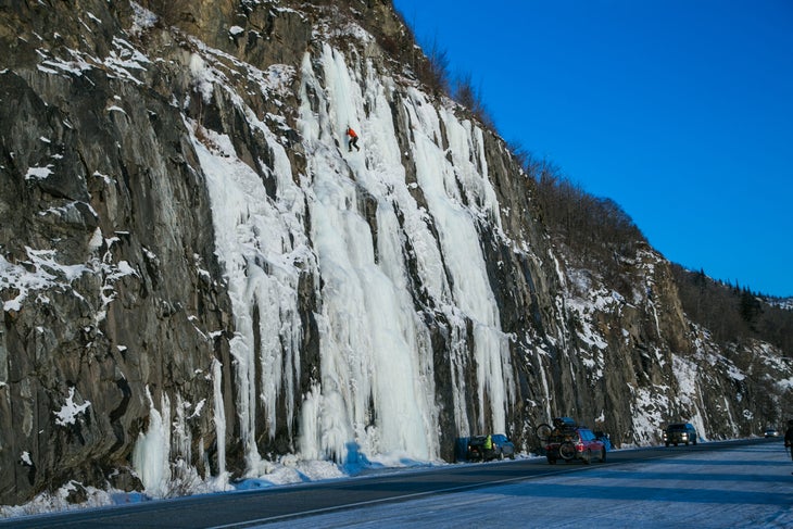 An unnamed climber attempts 'Roadside Attraction' (WI4) along the Seward Highway.