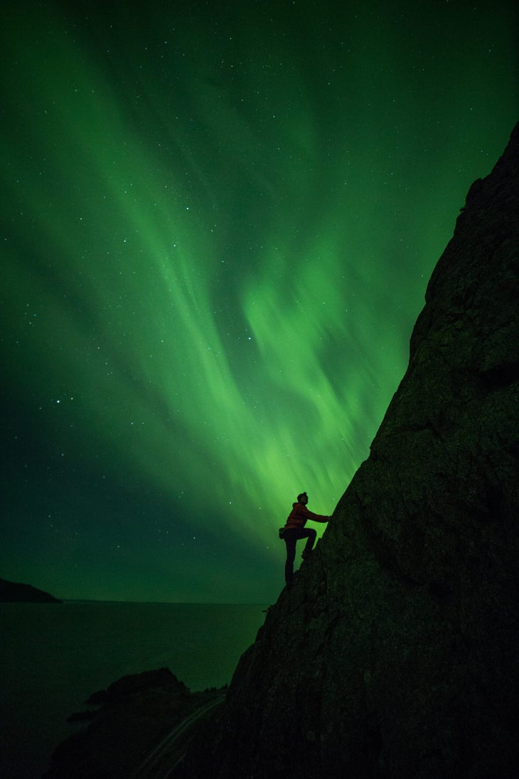 Wongi Kim climbs along Alaska's Seward Highway in full view of the northern lights.