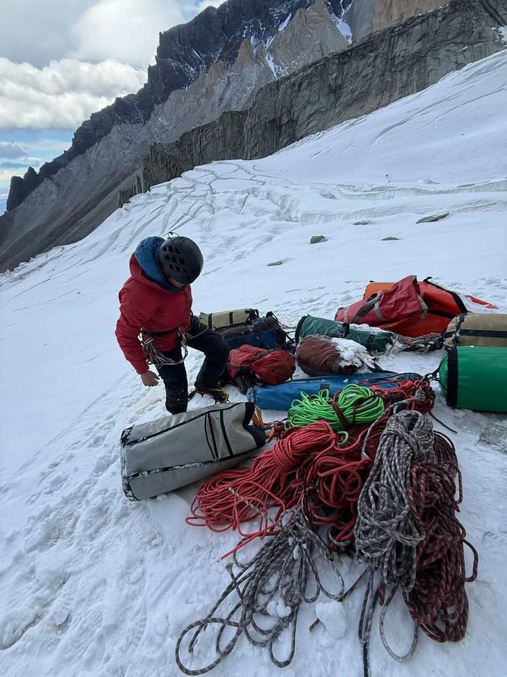 Climber deals with piles of rope on a glacier after climbing a big wall.