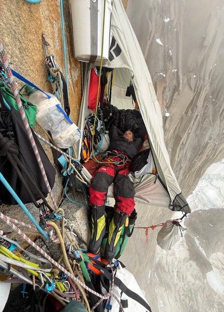 Climber lays in hanging camp in Patagonia.