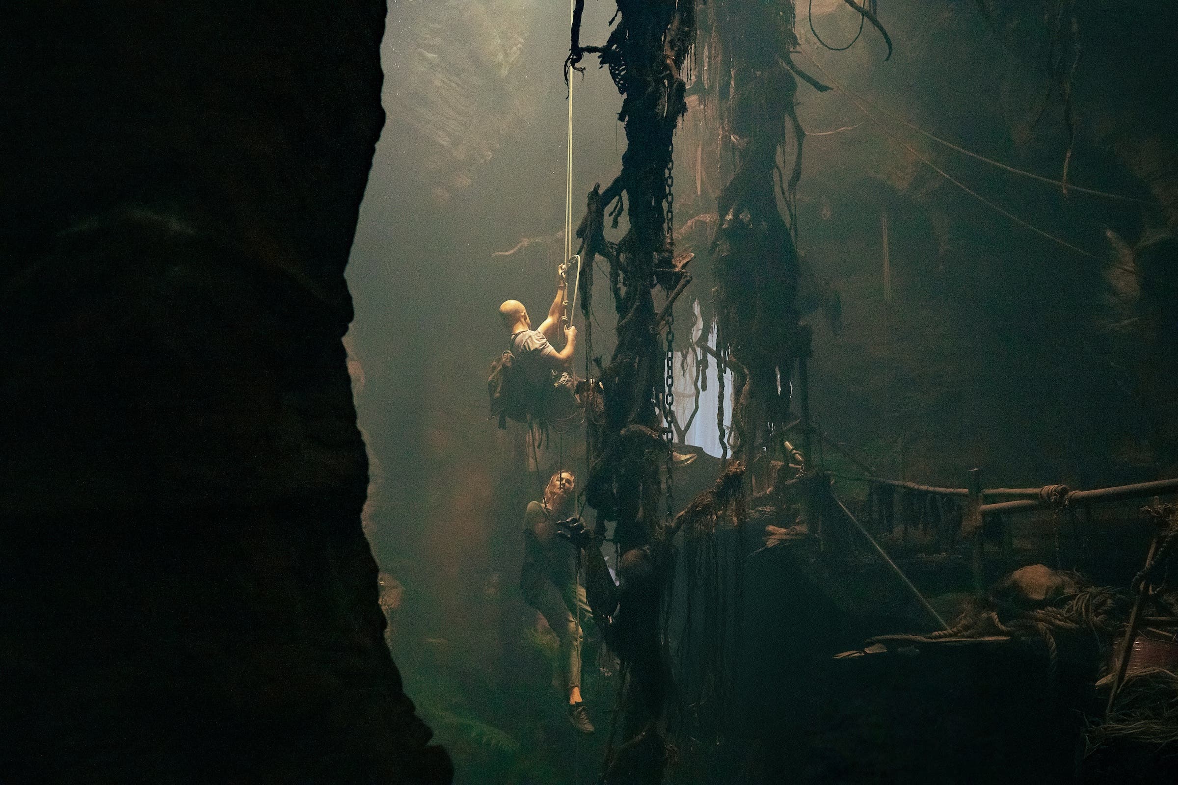 How Charlize Theron Learned to Climb for Netflix Thriller ‘Apex’ 1 Charlize Theron and Taron Egerton rappelling in a cave in 'Apex'