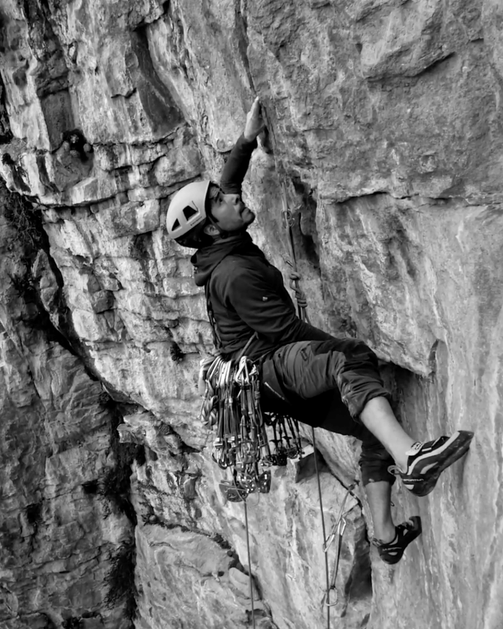 Man climbs steep limestone cliff in Mexico.