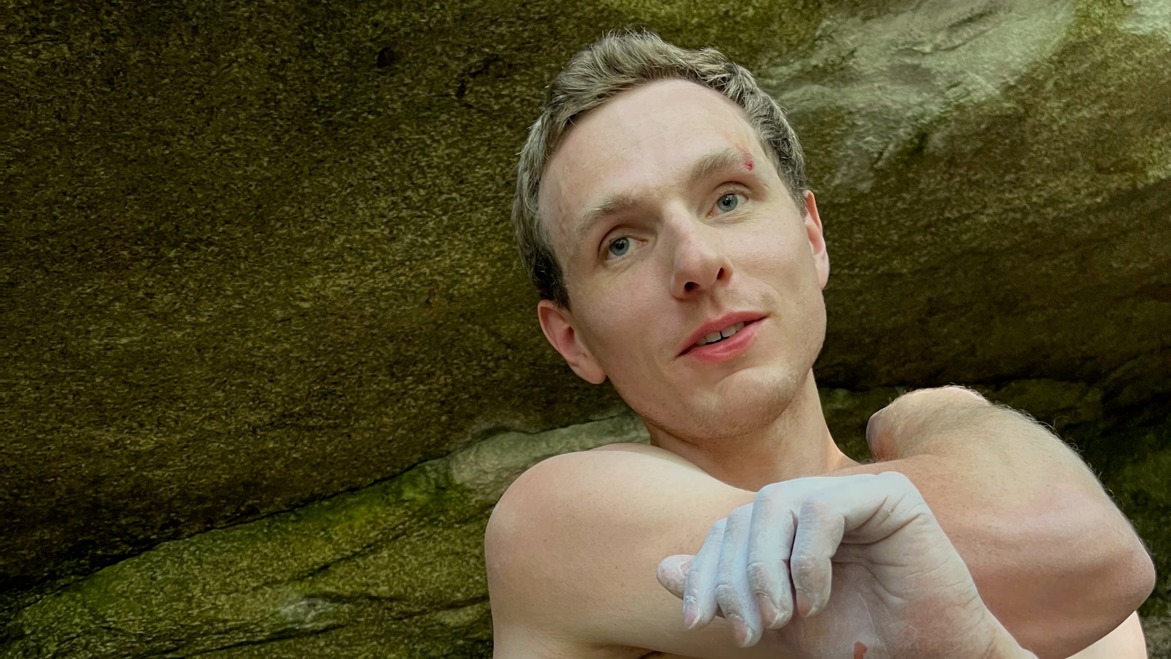 Gabe Lawson next to a boulder