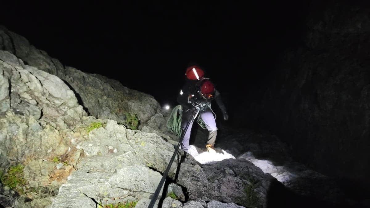 Brent Boulet rappels down toward the stuck climbers on 'White Dyke' the night of September 22, 2026.