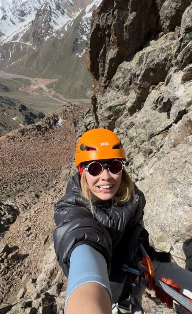 a selfie of a woman rappelling