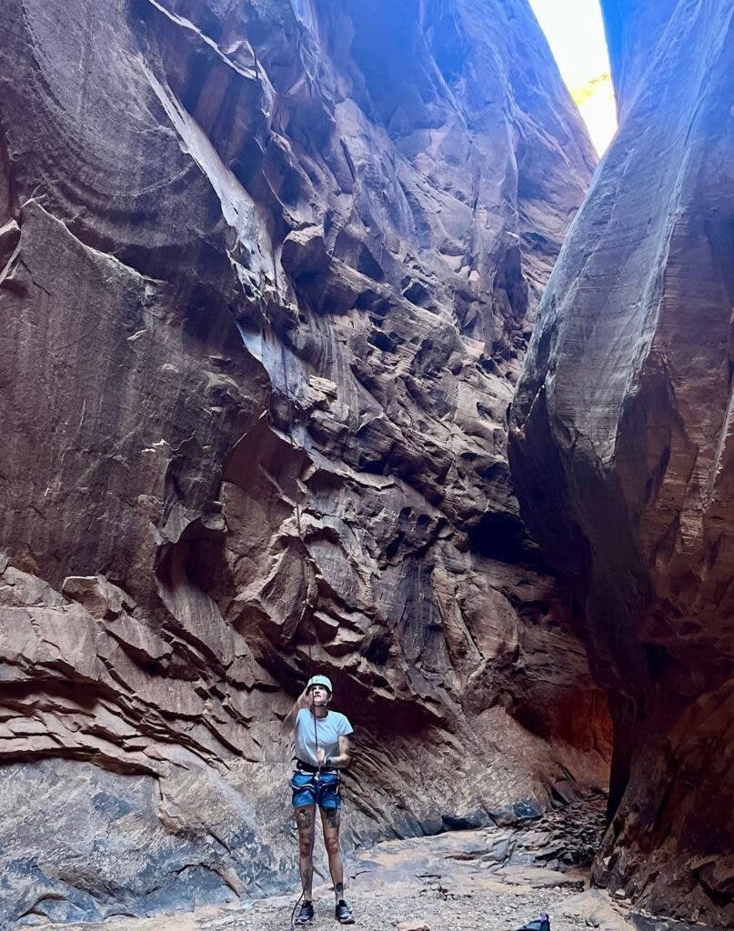 climber pulling rappel rope